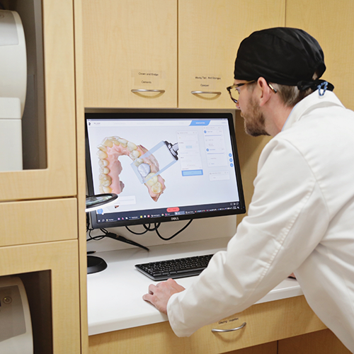 Man looking at image of teeth on computer monitor