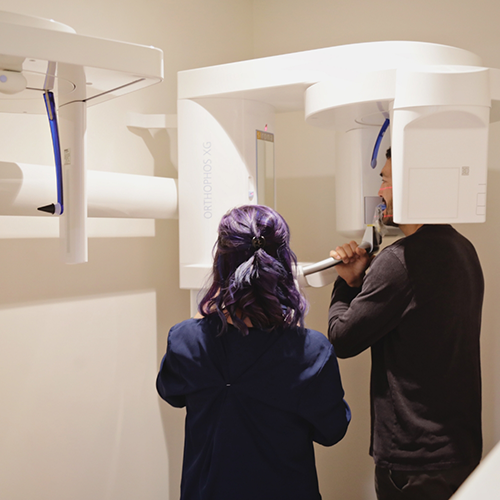 Dental patient about to be scanned by cone beam scanner