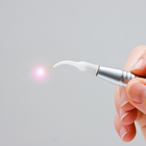 Close up of hand holding soft tissue laser