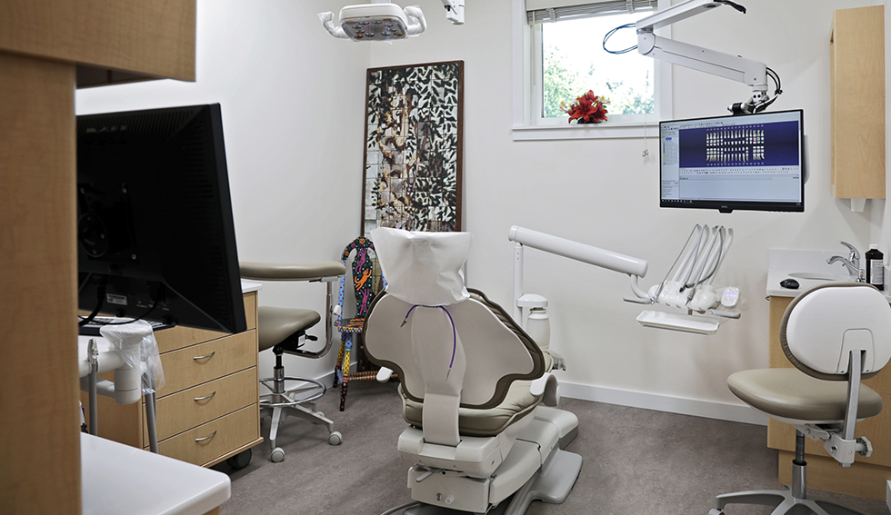 Dental treatment area with chair and monitors