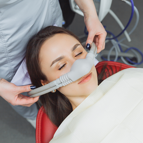 Female dental patient wearing nasal mask