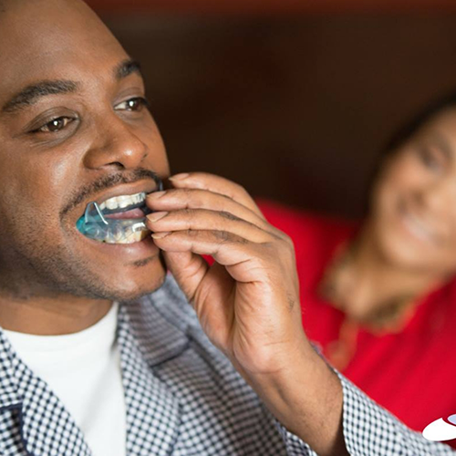 Man putting in oral appliance for sleep apnea